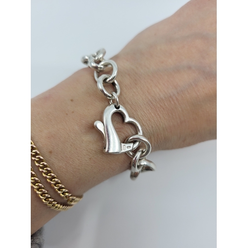 13 - A SILVER BRACELET, modelled with heart motifs