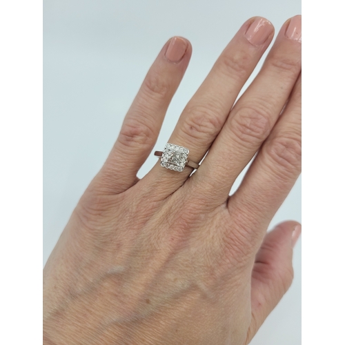 26 - A DIAMOND SQUARE CLUSTER RING, mounted in 9ct white gold. Estimated: weight of diamonds: 0.55 ct, si... 