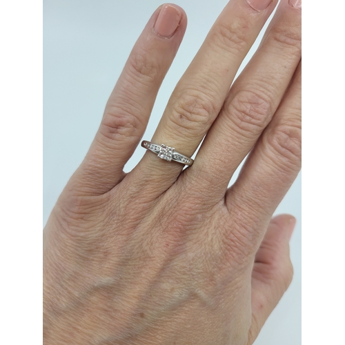 27 - A DIAMOND SQUARE CLUSTER RING, four princess cut diamonds to round brilliant cut diamond shoulders, ... 