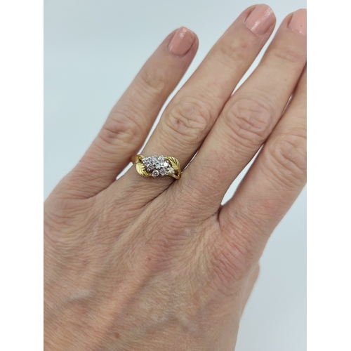 29 - AN IRISH DESIGNER RING, clusters of diamonds flanked by stylised leaf design to an 18ct yellow gold ... 
