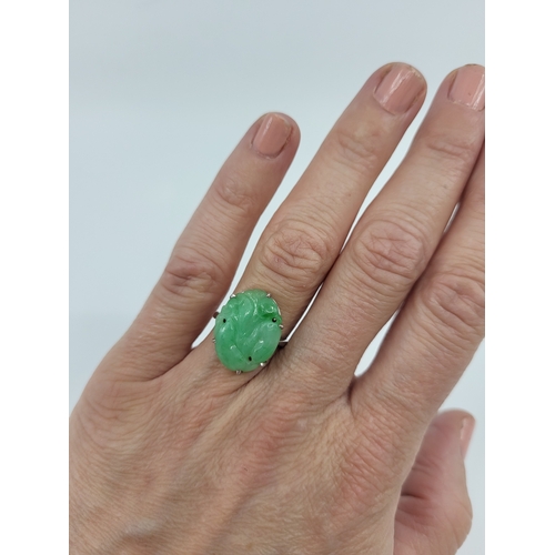 35 - A JADE SET RING, mounted in platinum, size