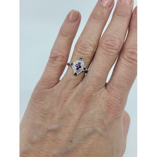 47 - AN AMETHYST AND DIAMOND SET CLUSTER RING, of plaque form mounted in silver. Estimated: weight of ame... 