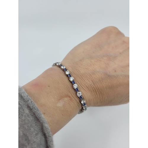 60 - A CUBIC ZIRCONIA SET TENNIS BRACELET, silver mounted