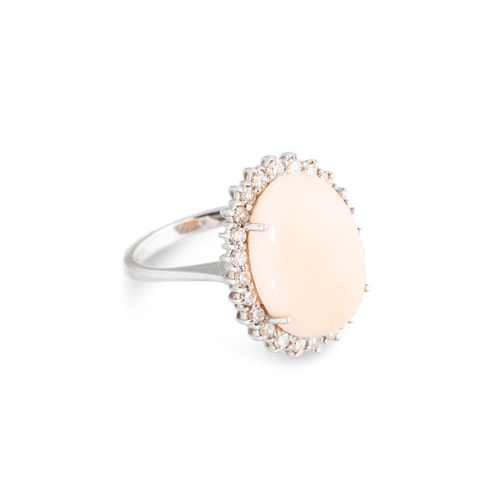 102 - A CORAL AND DIAMOND SET CLUSTER RING, the central 'angle skin' coral to eight cut diamond set surrou... 