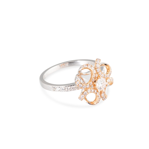 111 - A DIAMOND SET CLUSTER RING, unusual openwork form in white and yellow 18ct gold. Estimated: weight o... 