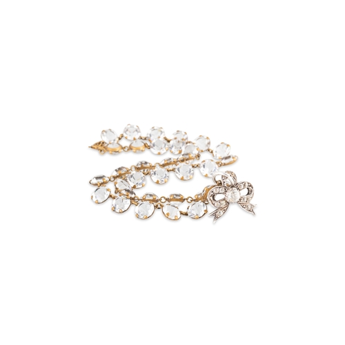 67 - A VINTAGE RIVIÉRE NECKLACE, set with old cut paste stones, suspending an antique silver mounted bow ... 