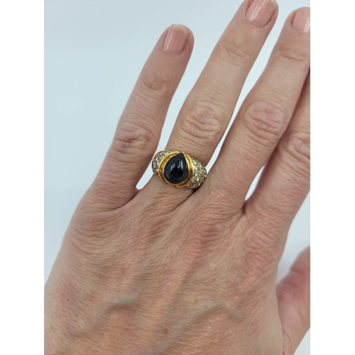 101 - A VINTAGE SAPPHIRE AND DIAMOND CLUSTER RING, the central pear cut cabochon sapphire to diamond set s... 