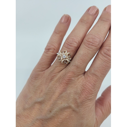 111 - A DIAMOND SET CLUSTER RING, unusual openwork form in white and yellow 18ct gold. Estimated: weight o... 