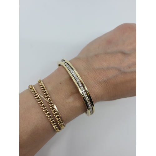 114 - A DIAMOND SET BANGLE, the round brilliant cut diamonds mounted in 14ct white and yellow gold. Estima... 