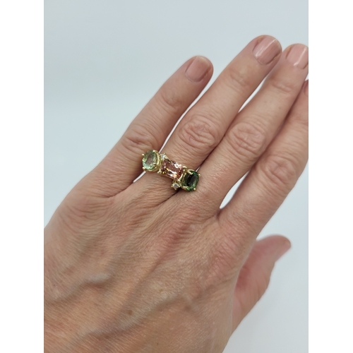 97 - A TOURMALINE AND DIAMOND RING, comprising pink and green tourmaline, offset by diamond accents, size... 