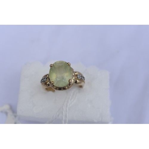 140 - 9CT GOLD DIAMOND AND PERIDOT RING