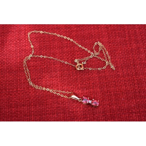 146 - 9CT GOLD DIAMOND AND RED IOLITE PENDANT ON 9CT GOLD CHAIN