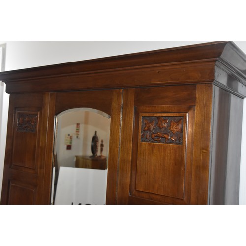 16 - EDWARDIAN CARVED PANEL DOUBLE ROBE WITH CENTER MIRRORED DOOR