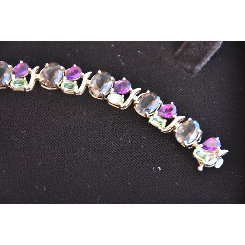 242 - 9CT GOLD PERIDOT AMETHYST AND SMOKEY QUARTZ BRACELET BOXED