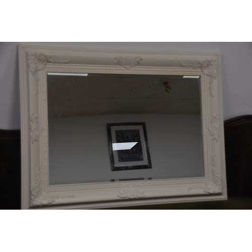 262 - BEVELLED EDGED MIRROR WITH ORNATE WHITE FRAME OVERALL MEASURING 45