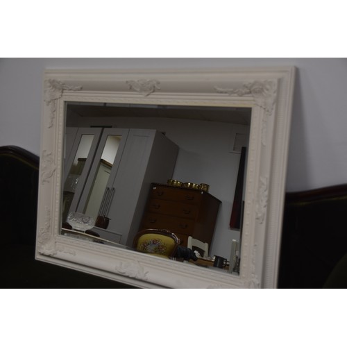 262 - BEVELLED EDGED MIRROR WITH ORNATE WHITE FRAME OVERALL MEASURING 45