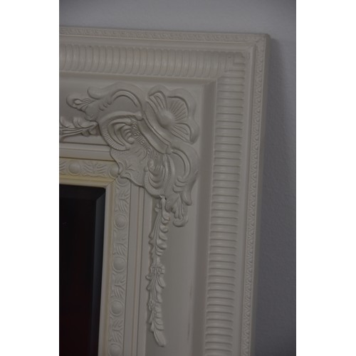 262 - BEVELLED EDGED MIRROR WITH ORNATE WHITE FRAME OVERALL MEASURING 45