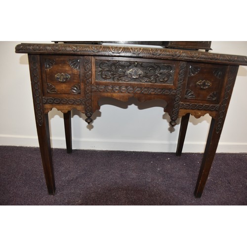 284 - HEAVILY CARVED GOTHIC GEORGIAN LADIES DESK THE TOP WITH  CARVED DOORS AND BANK OF 3 DRAWERS BEHIND E... 