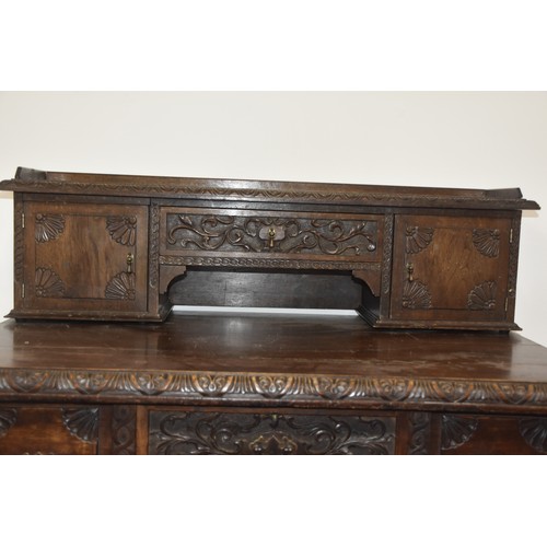 284 - HEAVILY CARVED GOTHIC GEORGIAN LADIES DESK THE TOP WITH  CARVED DOORS AND BANK OF 3 DRAWERS BEHIND E... 