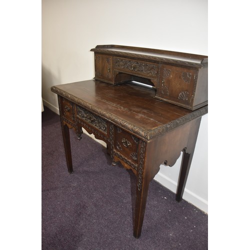 284 - HEAVILY CARVED GOTHIC GEORGIAN LADIES DESK THE TOP WITH  CARVED DOORS AND BANK OF 3 DRAWERS BEHIND E... 