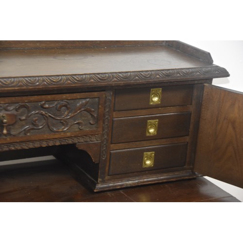 284 - HEAVILY CARVED GOTHIC GEORGIAN LADIES DESK THE TOP WITH  CARVED DOORS AND BANK OF 3 DRAWERS BEHIND E... 