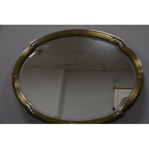 295 - GILT OVAL BEVELLED MIRROR