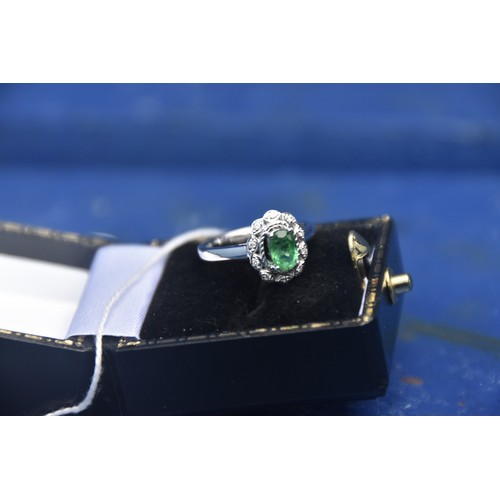 250 - 18CT EMERALD AND DIAMOND CLUSTER RING IN WHITE GOLD RING SIZE J (CAN BE RESIZED)