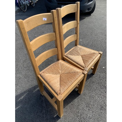 64 - 2 OAK LADDER BACK CHAIRS