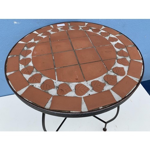 31 - A TILED TOP TABLE ON A CAST BASE