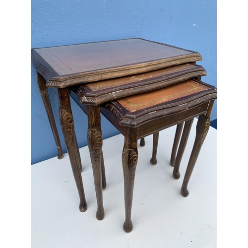 73 - A  MAHOGANY GLASS TOPPED NEST OF TABLES