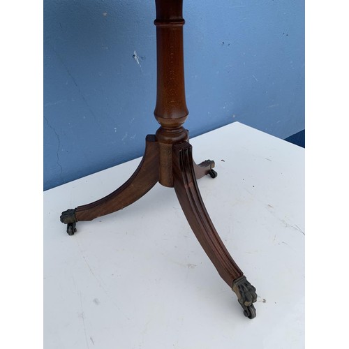 110 - A ROUND LEATHER TOP PEDESTAL TABLE WITH BRASS GALLERY