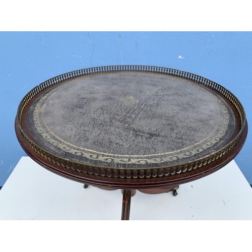 110 - A ROUND LEATHER TOP PEDESTAL TABLE WITH BRASS GALLERY