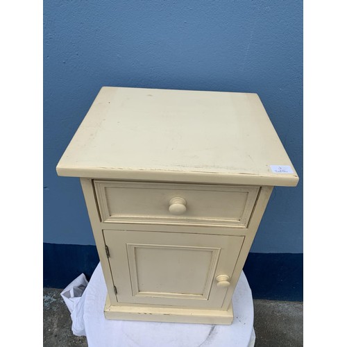 52 - A STRESSED CREAM BEDSIDE WITH DRAWER