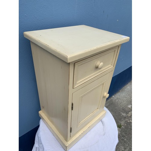 52 - A STRESSED CREAM BEDSIDE WITH DRAWER