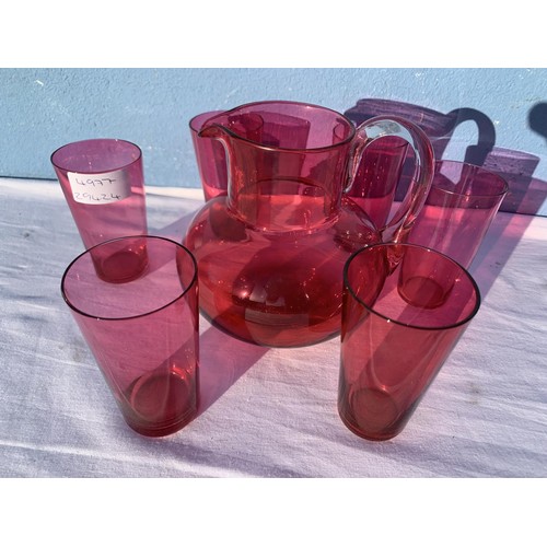 90 - RUBY JUG WITH CLEAR GLAS HANDLE AND 6 RUBY GLASSES