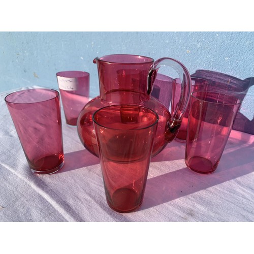 90 - RUBY JUG WITH CLEAR GLAS HANDLE AND 6 RUBY GLASSES