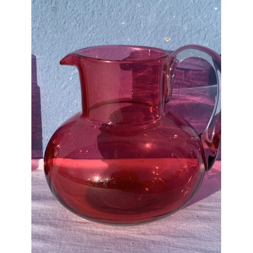 90 - RUBY JUG WITH CLEAR GLAS HANDLE AND 6 RUBY GLASSES