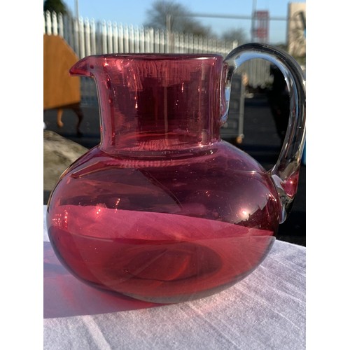 90 - RUBY JUG WITH CLEAR GLAS HANDLE AND 6 RUBY GLASSES