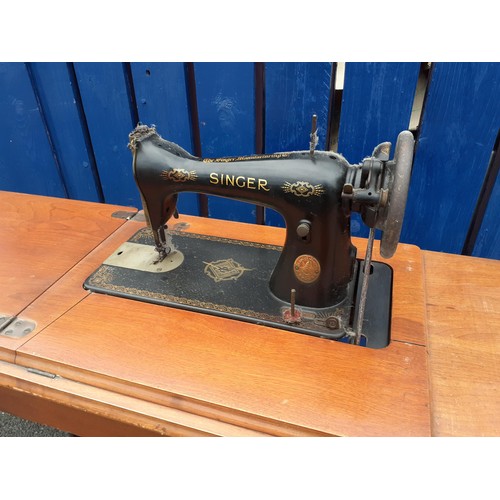 110 - A CAST BASE TREADLE SINGER SEWING MACHINE IN GOOD CONDITION