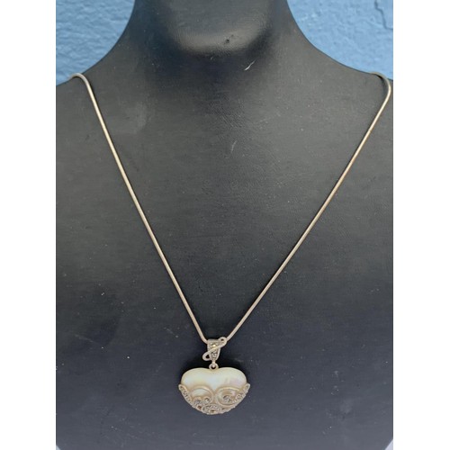 218 - SILVER MOUNTED MAP AND MARCASITE HEART PENDANT ON SILVER CHAIN