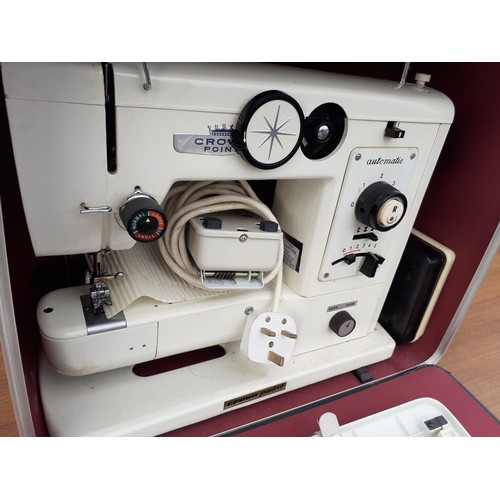 143 - A CASED SEWING MACHINE