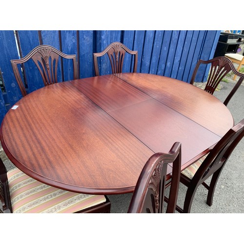 51 - MAHOGANY ROUND EXTENDING TABLE ON BRASS CASTOR WITH 6 SHEIF BACK CHAIRS