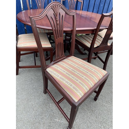 51 - MAHOGANY ROUND EXTENDING TABLE ON BRASS CASTOR WITH 6 SHEIF BACK CHAIRS