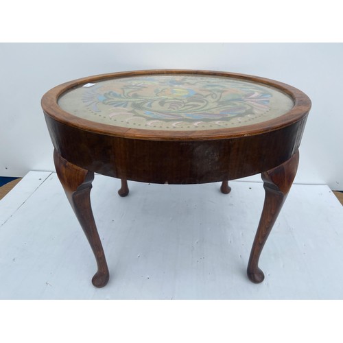 55 - A MAHOGANY  CIRCULAR TABLE WITH A TAPESTRY SET UNDER GLASS TOP