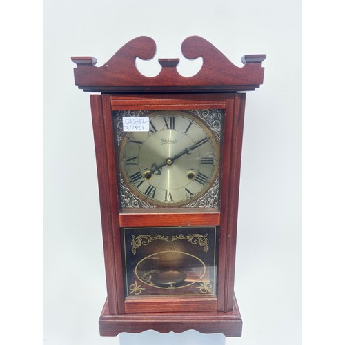 57 - A MAHOGANY WALL CLOCK WITH KEY AND PENDULUM