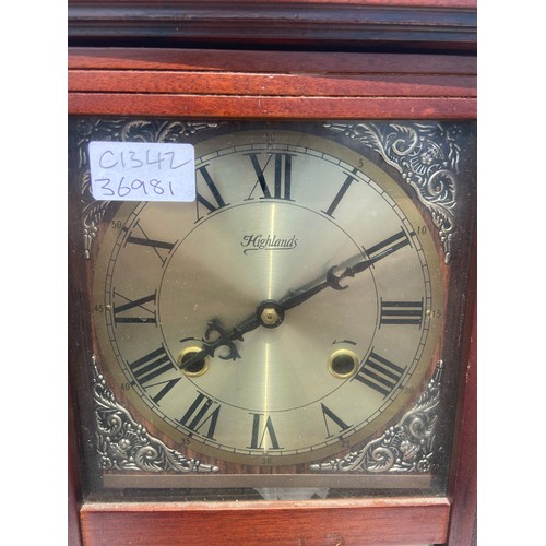 57 - A MAHOGANY WALL CLOCK WITH KEY AND PENDULUM