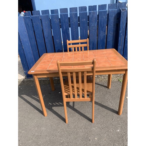 59 - A TILED TOP DINING TABLE AND 2 CHAIRS IN BEECH FINISH SOME MARKS