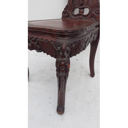 302 - A HEAVILY CARVED ORIENTAL STYLE SIDECHAIR