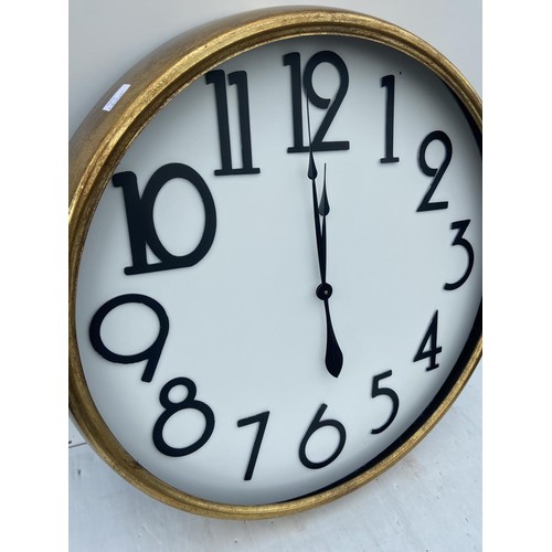 194 - A LARGE CIRCULAR GILT CLOCK (NO GLASS) 30