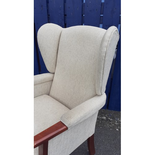 46 - A WINGBACK ARMCHAIR IN BISCUIT FINISH